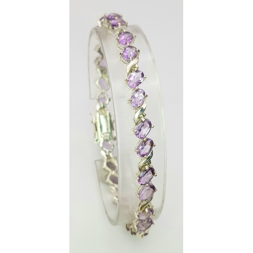 944 - An Attractive Sterling Silver and Amethyst Set Tennis Bracelet-19cm Length. 5mm Width. Set with twen... 