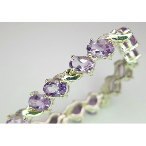 944 - An Attractive Sterling Silver and Amethyst Set Tennis Bracelet-19cm Length. 5mm Width. Set with twen... 