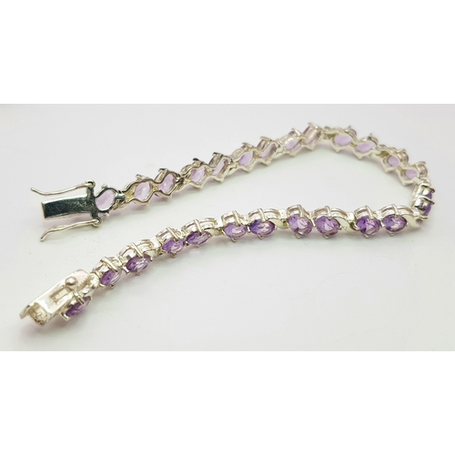 944 - An Attractive Sterling Silver and Amethyst Set Tennis Bracelet-19cm Length. 5mm Width. Set with twen... 
