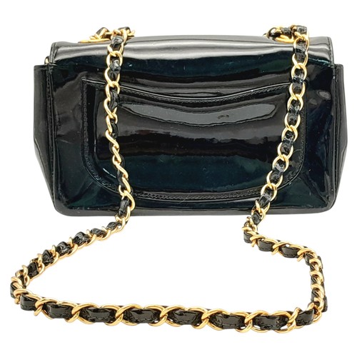 622 - A Chanel Camellia Flap Bag in Black Patent Leather. Exterior open pocket. Gold tone hardware. Classi... 