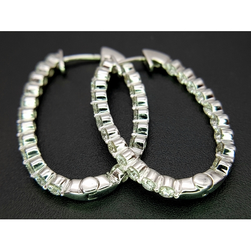1009 - A Pair of 18K White Gold and Diamond Elongated Hoop Earrings. 2.2ctw of round brilliant cut diamonds... 