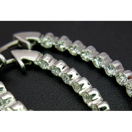 1009 - A Pair of 18K White Gold and Diamond Elongated Hoop Earrings. 2.2ctw of round brilliant cut diamonds... 