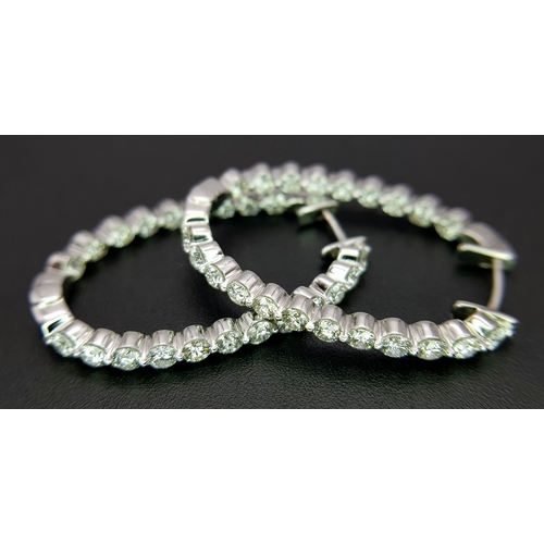 1009 - A Pair of 18K White Gold and Diamond Elongated Hoop Earrings. 2.2ctw of round brilliant cut diamonds... 