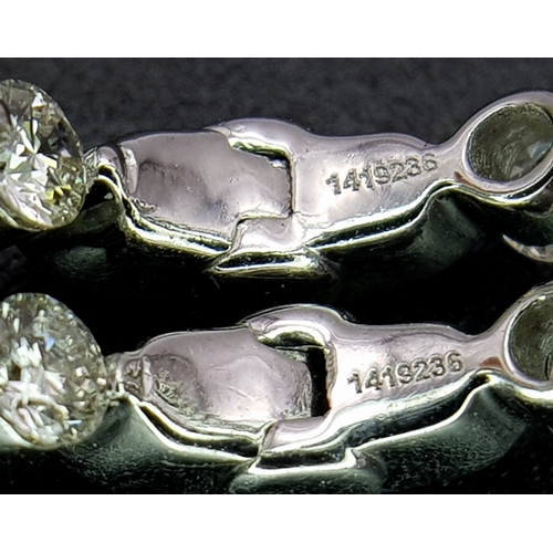 1009 - A Pair of 18K White Gold and Diamond Elongated Hoop Earrings. 2.2ctw of round brilliant cut diamonds... 