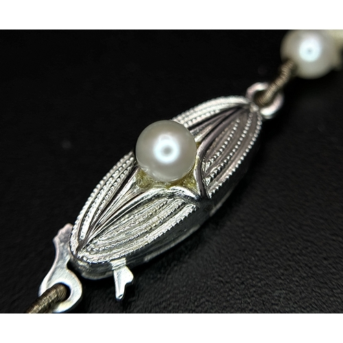 1213 - A Vintage Cultured Pearl Necklace. Sterling silver clasp. 54cm length. STK025060
