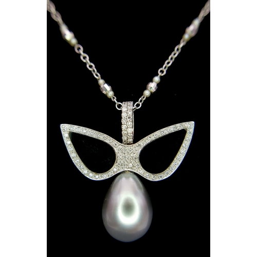 1269 - An Angelic 18K Gold, Tahitian Pearl and Black Onyx Pendant on an 18K White Gold Fancy Chain. Pendant... 