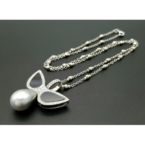 1269 - An Angelic 18K Gold, Tahitian Pearl and Black Onyx Pendant on an 18K White Gold Fancy Chain. Pendant... 