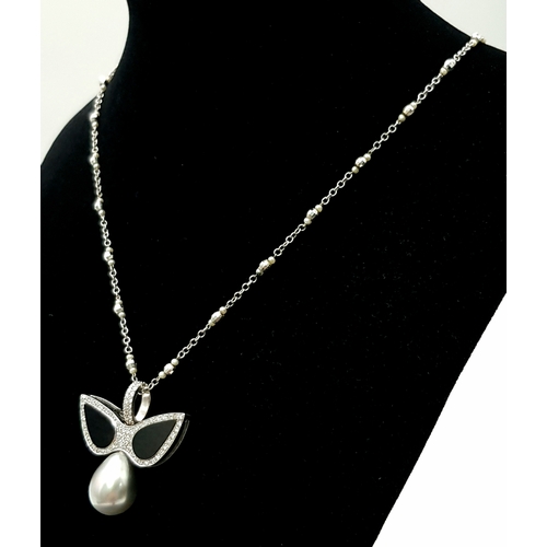 1269 - An Angelic 18K Gold, Tahitian Pearl and Black Onyx Pendant on an 18K White Gold Fancy Chain. Pendant... 