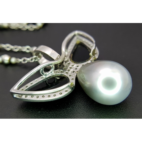 1269 - An Angelic 18K Gold, Tahitian Pearl and Black Onyx Pendant on an 18K White Gold Fancy Chain. Pendant... 