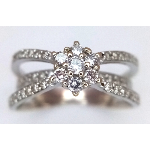 1360 - An 18K White Gold Diamond Crossover Pave Set and Cluster Ring. Size M. 4.3g. Ref: 8.11