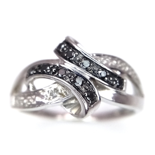 1862 - A 9K Yellow Gold Sapphire and Diamond Crossover Ring. Size J 1/2. 2.4g. Ref: 8.3