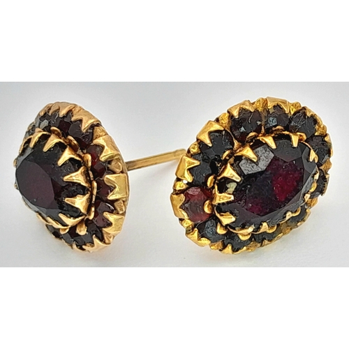 1214 - A Pair of 18K Gold (tests as) Garnet Cluster Stud Earrings. 1.95g.