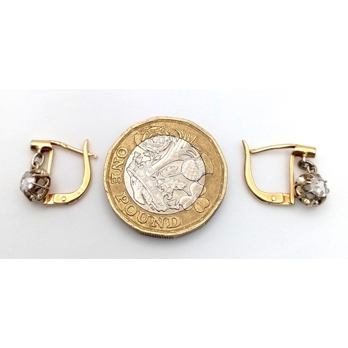 1170 - A Pair of Antique Dormeuse 18K Gold (tests as) Diamond Lever-back Earrings. 0.3ctw old cut diamonds.... 