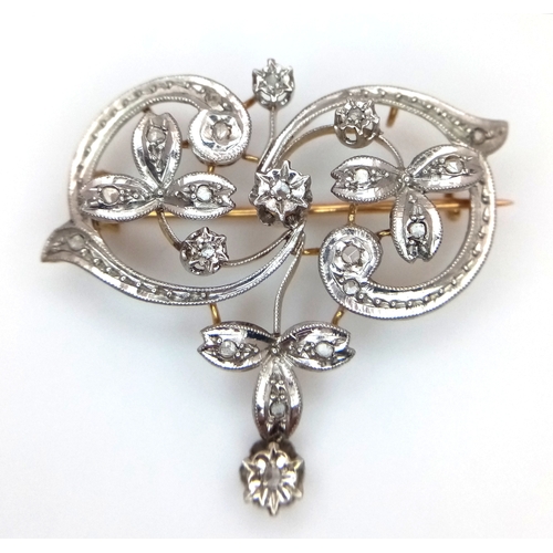 861 - An Antique 18K Yellow Gold, Platinum (tests as) and Diamond Victorian Brooch. Floral scrolled form w... 