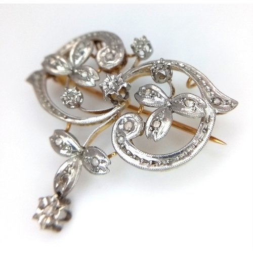 861 - An Antique 18K Yellow Gold, Platinum (tests as) and Diamond Victorian Brooch. Floral scrolled form w... 