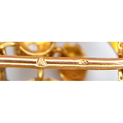 861 - An Antique 18K Yellow Gold, Platinum (tests as) and Diamond Victorian Brooch. Floral scrolled form w... 