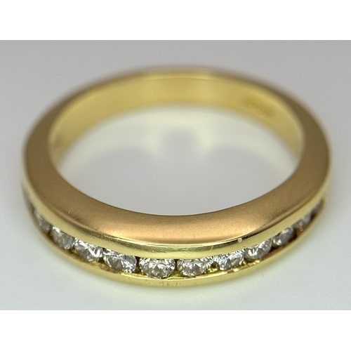 1432 - An 18K Yellow Gold, Diamond Channel Set Ring. 14 diamonds - 0.50ctw. Size N. 5.4g.