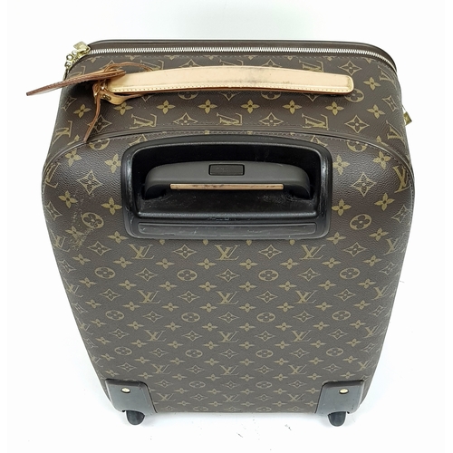790 - A Louis Vuitton Monogram Canvas Rolling Travel Bag. Large exterior pocket and zipped compartment. Sp... 