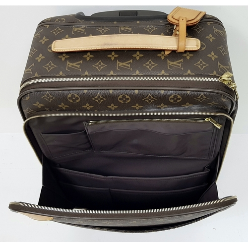 790 - A Louis Vuitton Monogram Canvas Rolling Travel Bag. Large exterior pocket and zipped compartment. Sp... 