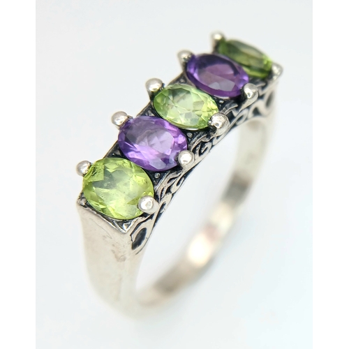 1196 - A Vintage Sterling Silver Amethyst and Peridot Ring Size S. The Ring is set with 5mm Long Oval Cut A... 