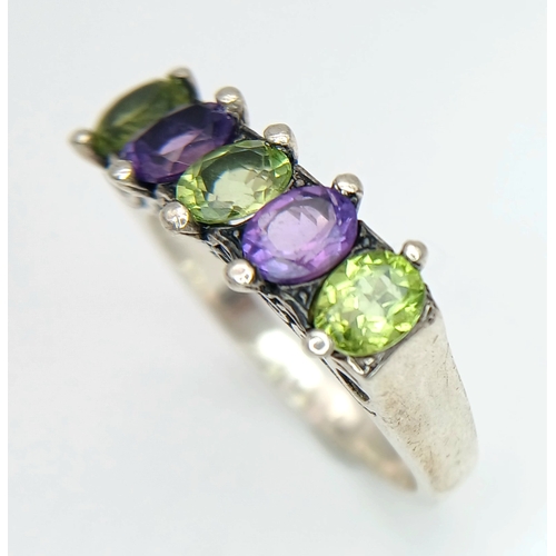 1196 - A Vintage Sterling Silver Amethyst and Peridot Ring Size S. The Ring is set with 5mm Long Oval Cut A... 