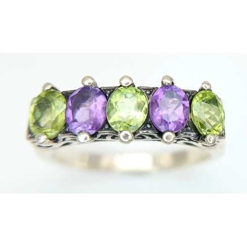 1196 - A Vintage Sterling Silver Amethyst and Peridot Ring Size S. The Ring is set with 5mm Long Oval Cut A... 