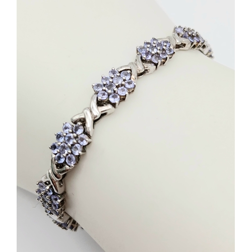 705 - An Eye-Catching Sterling Silver and Tanzanite Set Tennis Bracelet-20cm Length, 7mm Width. Set with c... 