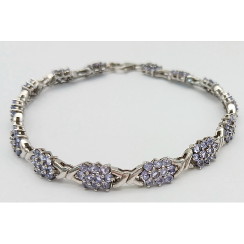 705 - An Eye-Catching Sterling Silver and Tanzanite Set Tennis Bracelet-20cm Length, 7mm Width. Set with c... 