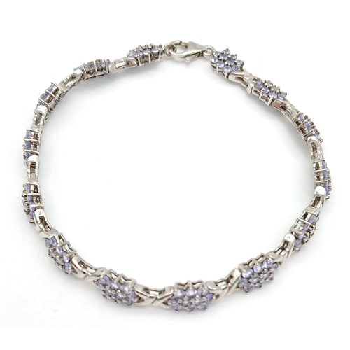 705 - An Eye-Catching Sterling Silver and Tanzanite Set Tennis Bracelet-20cm Length, 7mm Width. Set with c... 