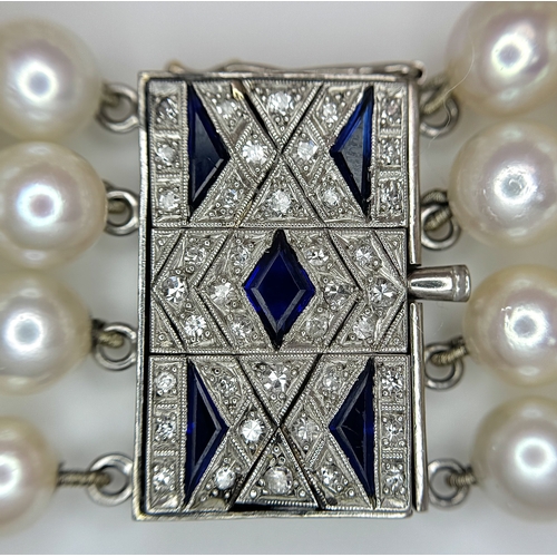 47 - A FOUR ROW AKOYA PEARL BRACELET WITH A 14K WHITE GOLD DIAMOND AND SAPPHIRE SET CLASP. A BEAUTIFUL PI... 