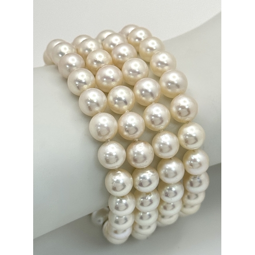 47 - A FOUR ROW AKOYA PEARL BRACELET WITH A 14K WHITE GOLD DIAMOND AND SAPPHIRE SET CLASP. A BEAUTIFUL PI... 