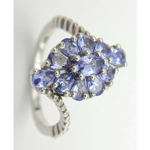 1683 - A Pretty Art Deco Style Sterling Silver Tanzanite Set Crossover Ring Size P. The Ring is set with Ov... 