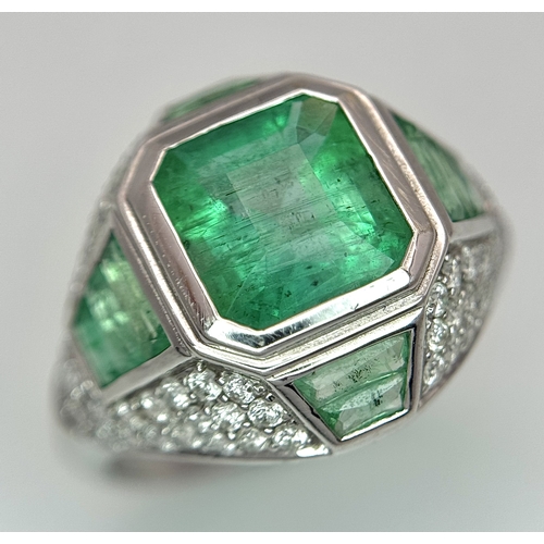 A Stunning W.G.I Certified 18K White Gold, Emerald and Diamond Ring. A 2.05ct Brazilian octagonal step cut emerald takes centre stage. 68 round brilliant cut diamonds and and 10 rectangular mixed cut emeralds complete this symphony. Diamonds - 1ctw. Accent emeralds - 0.70ctw. Size L 1/2. 3.91g total weight.