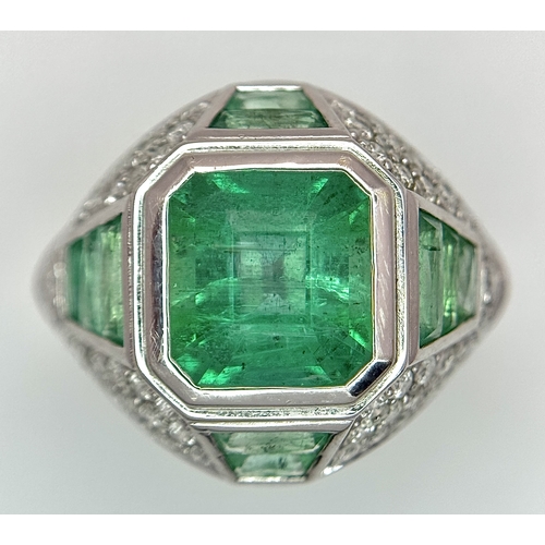 1572 - A Stunning W.G.I Certified 18K White Gold, Emerald and Diamond Ring. A 2.05ct Brazilian octagonal st... 