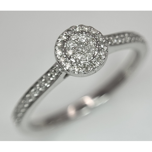 1075 - A 9K WHITE GOLD, DIAMOND SET HALO RING. 0.19Ct Total Diamond Weight, Total Weight 2.4G, SIZE P. TAN ... 