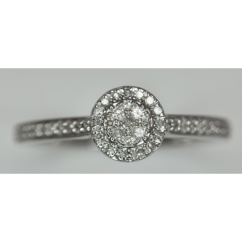 1075 - A 9K WHITE GOLD, DIAMOND SET HALO RING. 0.19Ct Total Diamond Weight, Total Weight 2.4G, SIZE P. TAN ... 