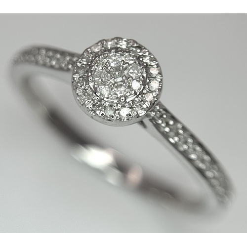 1075 - A 9K WHITE GOLD, DIAMOND SET HALO RING. 0.19Ct Total Diamond Weight, Total Weight 2.4G, SIZE P. TAN ... 