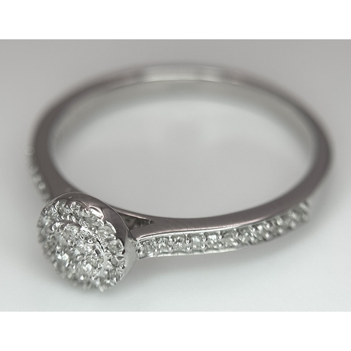 1075 - A 9K WHITE GOLD, DIAMOND SET HALO RING. 0.19Ct Total Diamond Weight, Total Weight 2.4G, SIZE P. TAN ... 