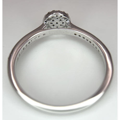 1075 - A 9K WHITE GOLD, DIAMOND SET HALO RING. 0.19Ct Total Diamond Weight, Total Weight 2.4G, SIZE P. TAN ... 