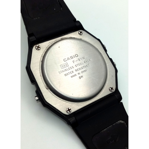 1115 - A CASIO, F - 91W DIGITAL, RUBBER STRAP WATCH. IN FULL WORKING ORDER. S/A 1317 - 1