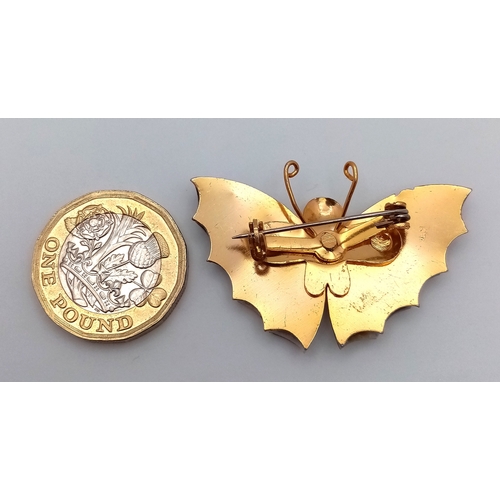 1093 - A vintage gilded butterfly brooch with tortoise shell wings. Total length 5cm.