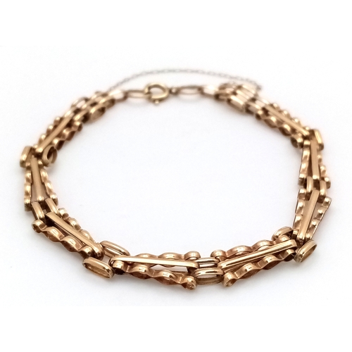 13 - A 9K GOLD SLIMLINE GATE BRACELET WITH SAFETY CHAIN .      4.2gms    19cms