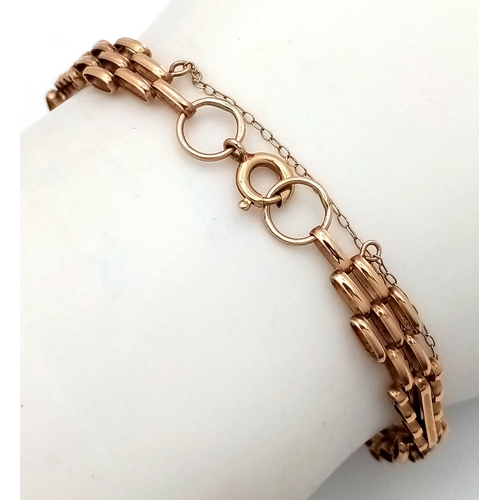 13 - A 9K GOLD SLIMLINE GATE BRACELET WITH SAFETY CHAIN .      4.2gms    19cms