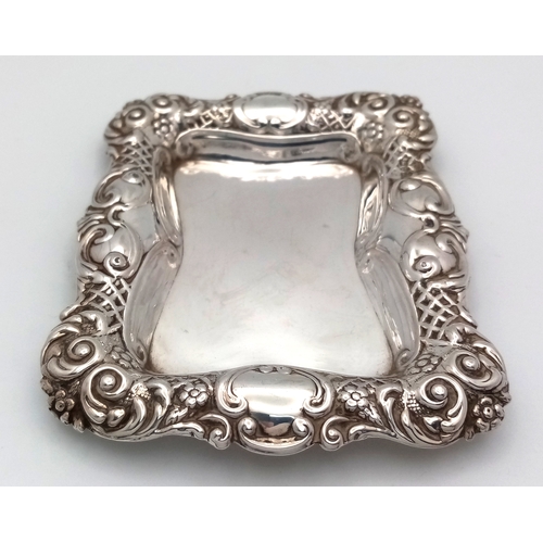 19 - AN ORNATE ANTIQUE SILVER TRUFFLE DISH HALLMARKED CHESTER 1726 HAVING HAND CHASED DESIGNED EDGES .   ... 