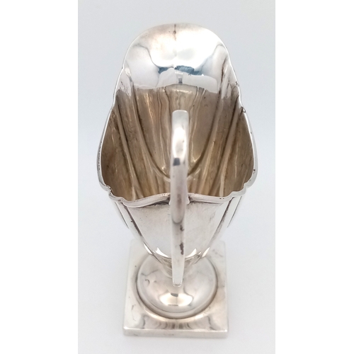 33 - A 1731 GEORGIAN SILVER ANTIQUE HELMET SHAPED CREAM JUG .        51gms    11.5cms