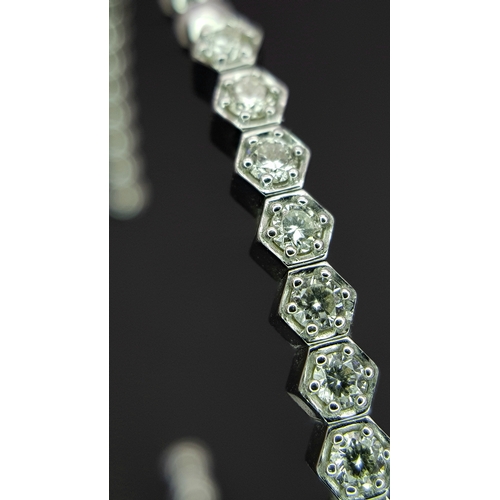 38 - A 14K WHITE GOLD BRACELET BANGLE. SET WITH SEVENTEEN 0.87CT ROUND BRILLIANT CUT NATURAL DIAMONDS. H/... 