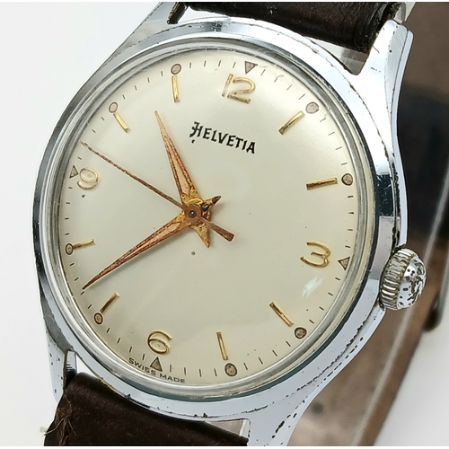 60 - A Vintage Helvetia Mechanical Gents Watch. Brown leather strap. Stainless steel case - 35mm. White d... 