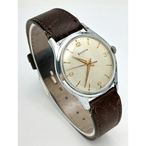 60 - A Vintage Helvetia Mechanical Gents Watch. Brown leather strap. Stainless steel case - 35mm. White d... 