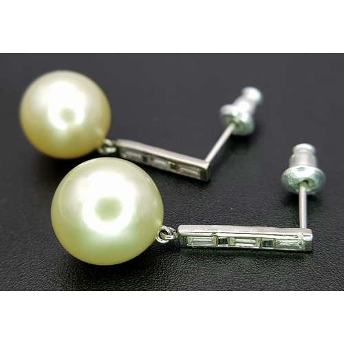 1063 - A Pair of 18K White Gold (tests as) Diamond and South Sea Pearl Drop Earrings. 11mm pearls. Baguette... 