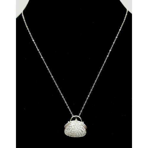 1070 - A 14K White Gold and Diamond Handbag Pendant on a 9K White Gold Chain. 18mm and 44cm. 3.4g. Ref: 6.3